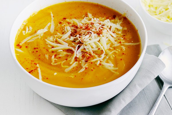 Smoky sweet potato soup Bowl of sweet potato soup, topped with grated cheese
