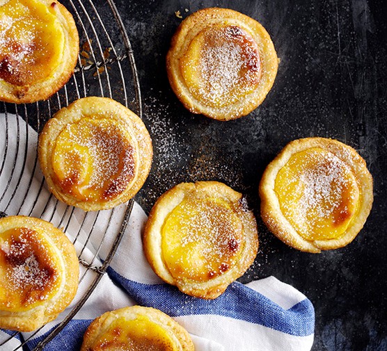 Portuguese custard tarts on a cooling rack