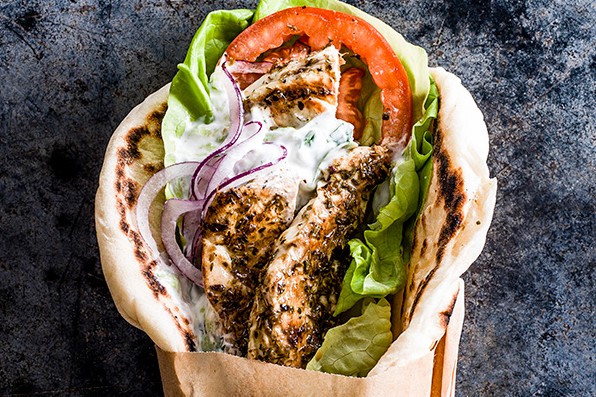 Chicken gyros Chicken gyros in a wrap with lettuce, tomatoes and tzatziki