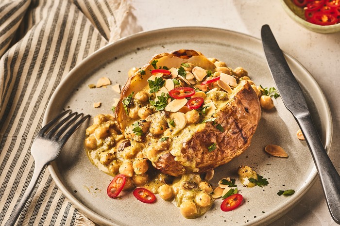 Curried chickpea baked potatoes A split jacket potato filled with chickpeas