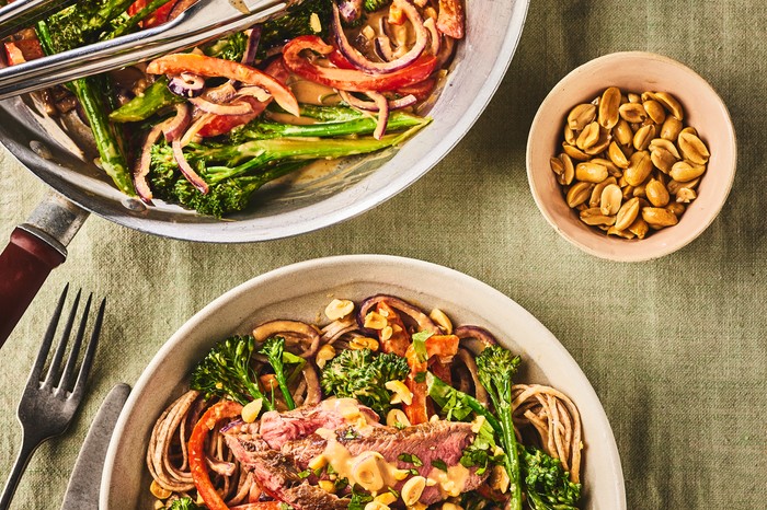 Peanut beef and pepper stir-fry Two bowls of pepper stir-fry with nuts on the side