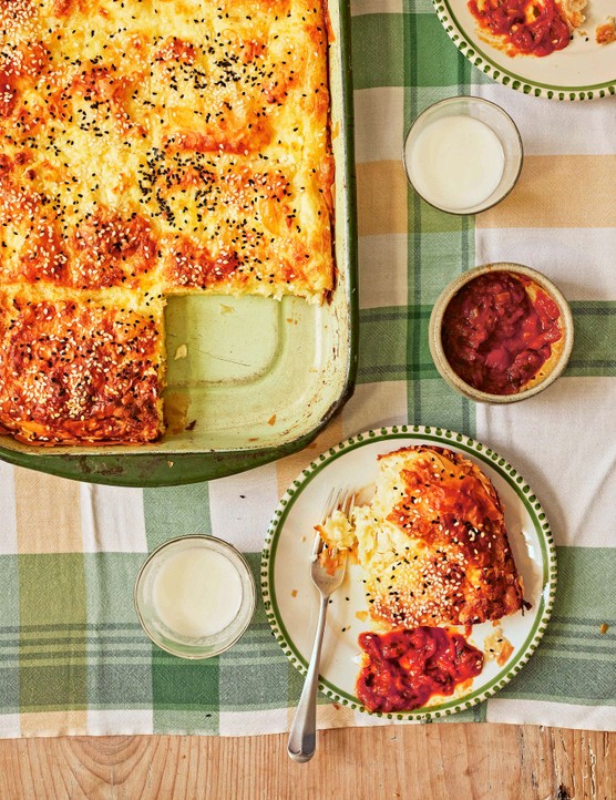 A cheese pie in its serving dish with one square out of it