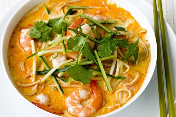 Prawn laksa (spicy noodle soup) A bowl of prawn noodle soup topped with coriander garnish