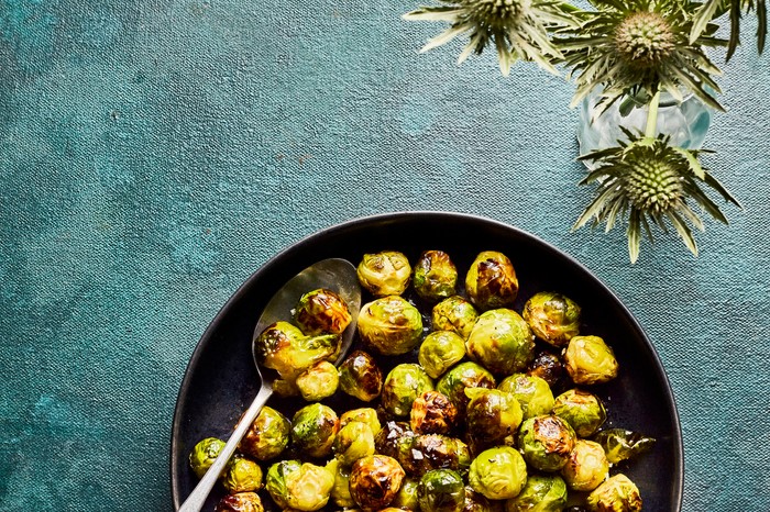 Air Fryer Brussels Sprouts A pan of brussels sprouts with decorative foliage on the side