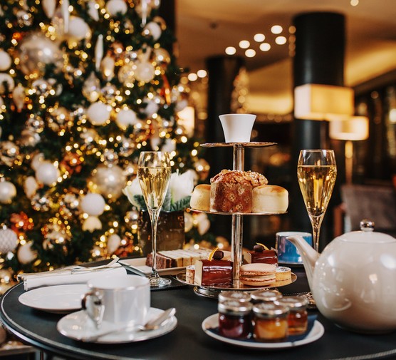 Best festive afternoon teas in London A tiered stand with a selection of cakes plus two glasses of champagne