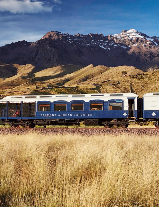 A train travelling against a scenic mountainous backdrop