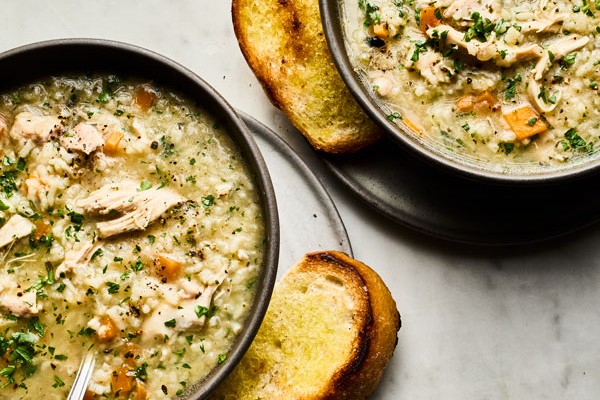 Chicken and rice soup Two bowls of chicken and rice soup with toasted bread