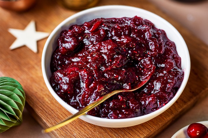 Cranberry and port sauce A shallow bowl fille with cranberry and port sauce with a spoon