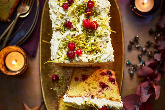 Cranberry cake An iced loaf cake with one slice taken out of it