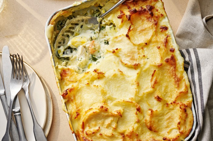 Florentine fish pie Baking dish of fish pie with a serving removed