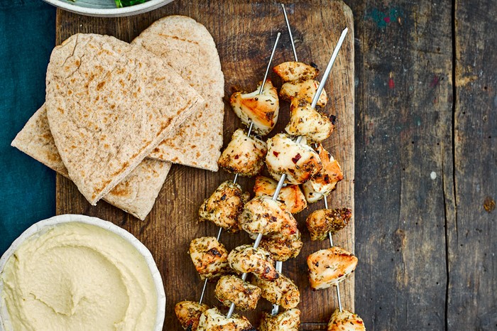 Greek chicken skewers Herby chicken skewers with pitta flatbreads and sald