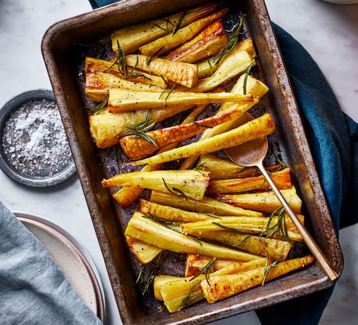 Honey-roasted parsnips Honey-roasted parsnips with rosemary on a baking tray