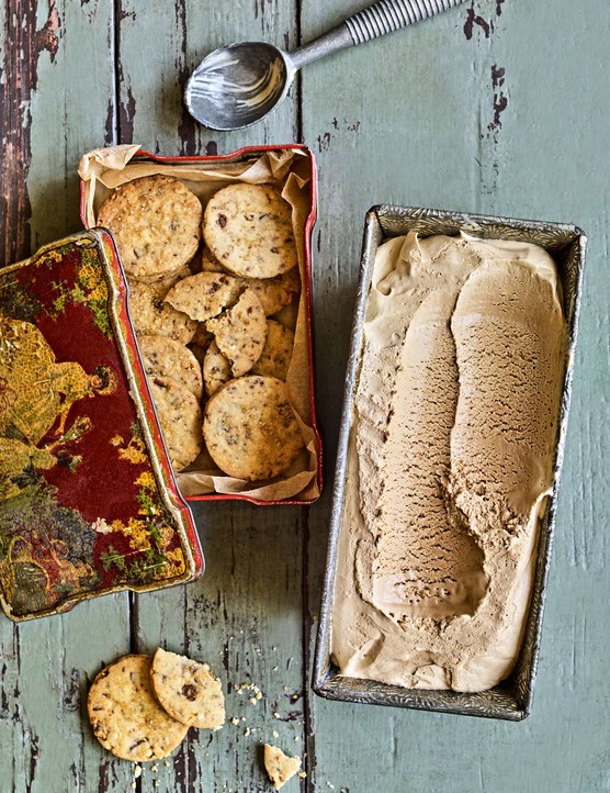 A tray of homemade ice cream with a tin of biscuits on the side