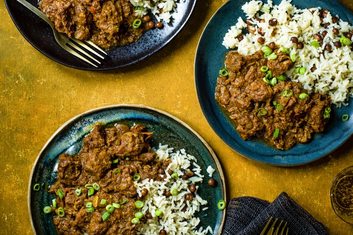 Jamaican Curry Pork Recipe three bowls of pork curry with rice and peas