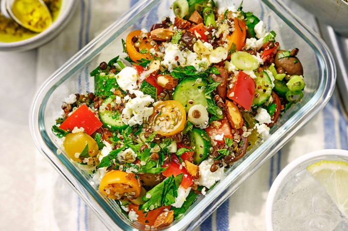 Mediterranean-inspired herby grain salad A glass bowl of herby salad with plenty of vegetables