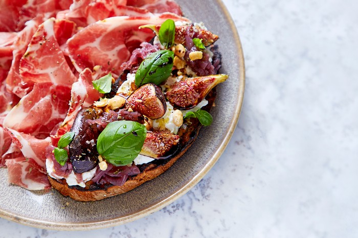 Burrata bruschetta with red onion jam Bruschetta with cured ham on the side