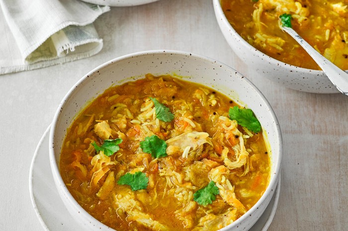 Mulligatawny Soup Recipe A bowl of mulligatawny soup with shredded chicken and herbs