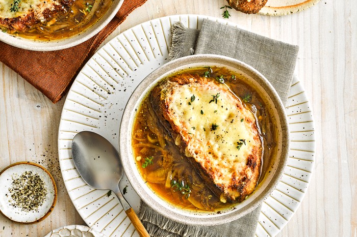 Vegetarian French onion soup A bowl of French onion soup with cheese on top
