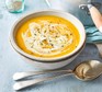 Carrot and Parsnip Soup Recipe Carrot and parsnip soup in a white bowl next to spoon