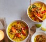 Carrot and parsnip dhal Two bowls filled with yellow dhal and topped with roast parsnips