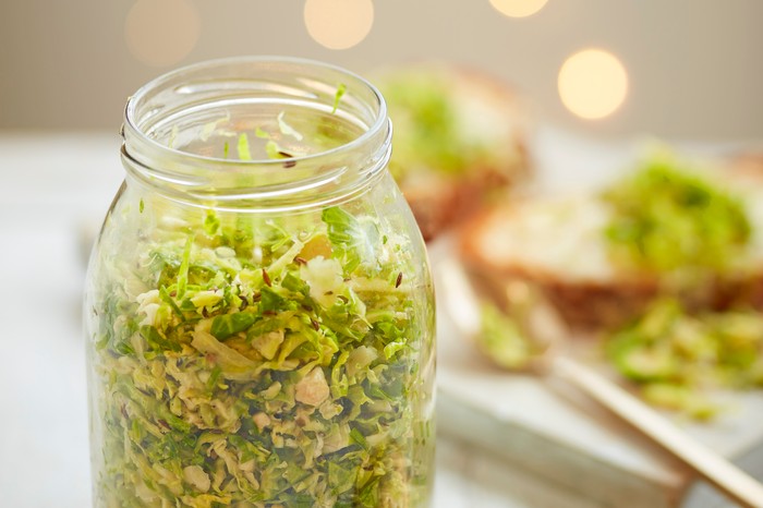 Brussels sprout sauerkraut A glass jar filled with shredded sprouts