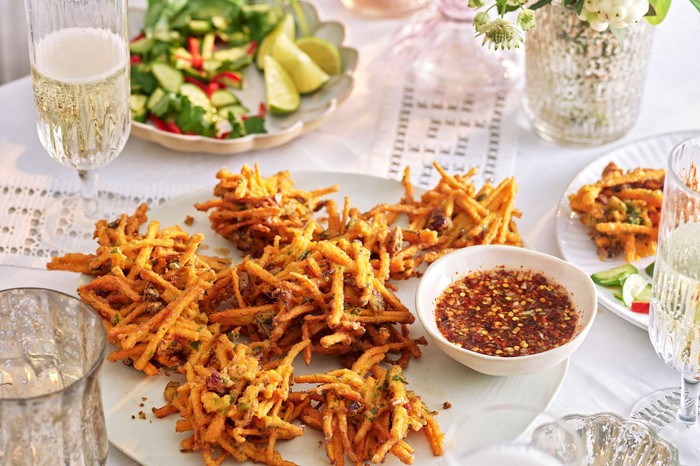 Sweet potato and cranberry fritters with nuoc cham Sweet potato and cranberry fritters with nuoc cham on a serving plate