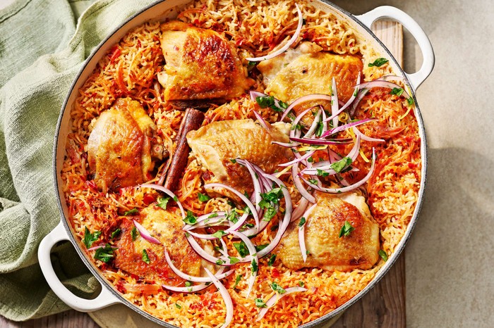 Harissa chicken and rice one-pot A one-pan chicken dish with red onion slices on top