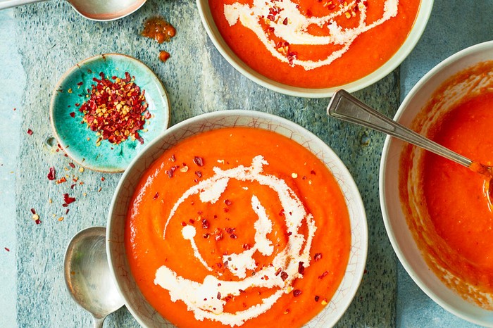 Red pepper soup Several bowls of red pepper soup, with a swirl of creme fraiche