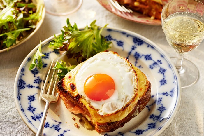 Croque madame with Marmite A croque madame topped with a fried egg with a salad on the side