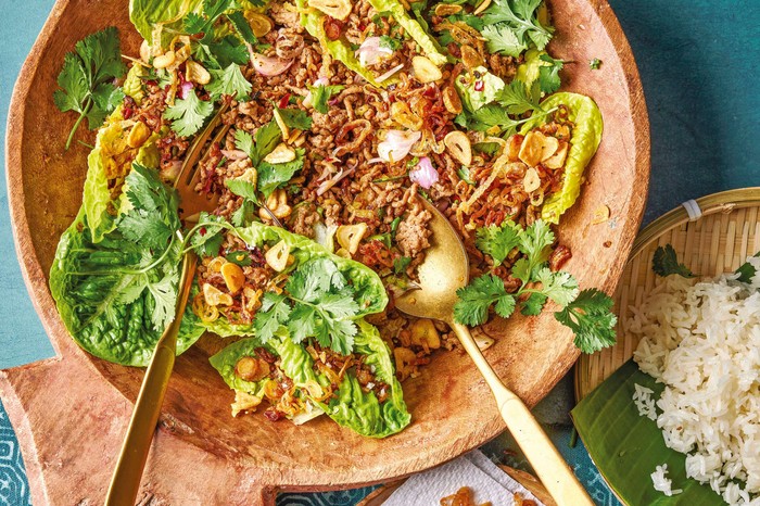A chopped Thai pork salad on top of leaves