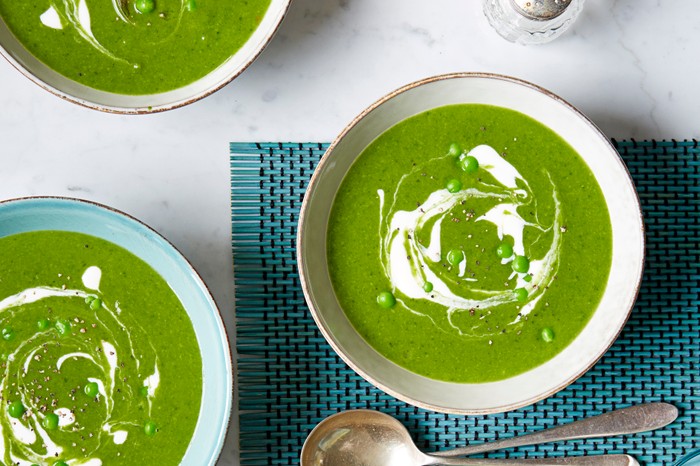 Spinach soup Three bowls of green spinach and pea soup, with a swirl of creme fraîche