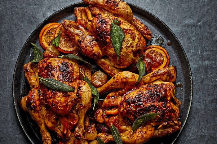 Provençal poussins with Épices Rabelais, shallots and dates A platter of cooked poussins topped with sage