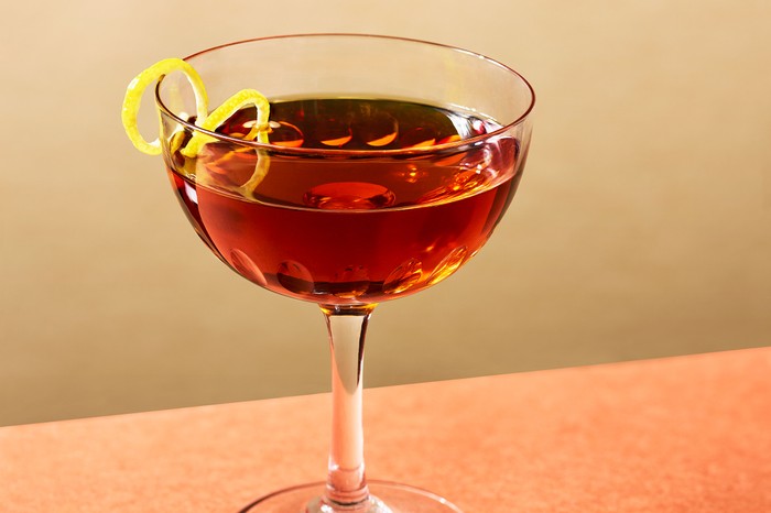 Rum vieux carré Coupe glass with lemon twist garnish and a rum vieux carré cocktail