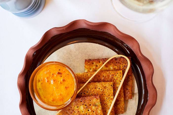 Socca with sa tartinade Square-shaped savoury pancakes on a plate with dip on the side