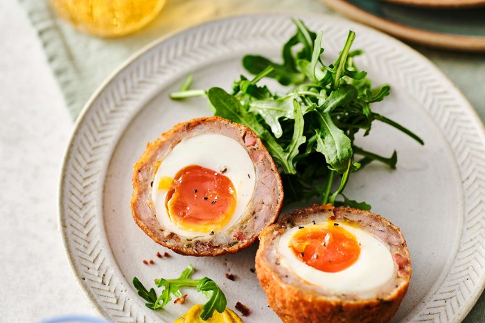 Italian sausage scotch eggs A homemade Italian sausage scotch egg cut in half with salad on the side