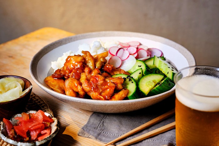 Japanese Teriyaki chicken A plate of Japanese Teriyaki chicken with a glass of beer on the side