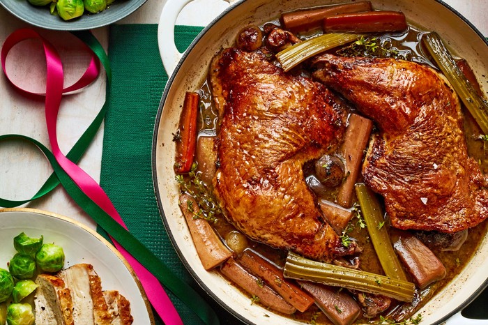 Turkey au vin A turkey dish in a large pot with a Christmas dinner on the side