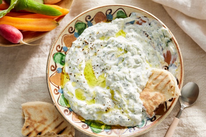 How to use leftover herbs A bowl of tzatziki with a flatbread dipped in