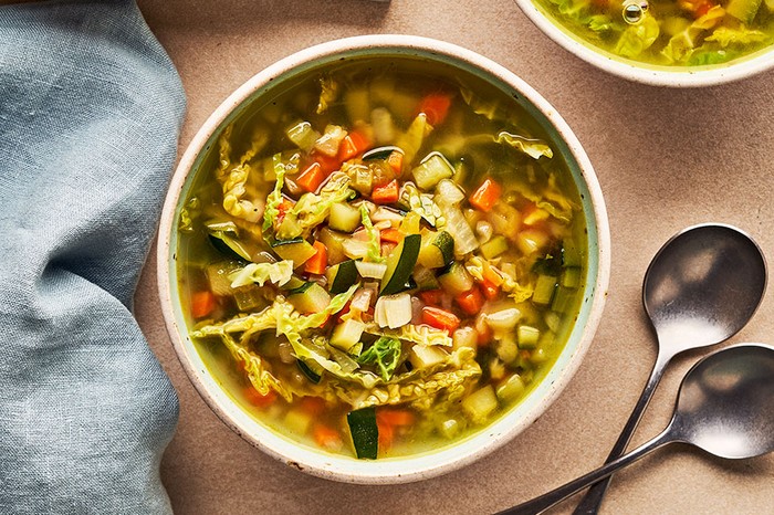 Vegetable soup Bowl of vegetable soup next to two slices of bread and a ramekin of lemon zest