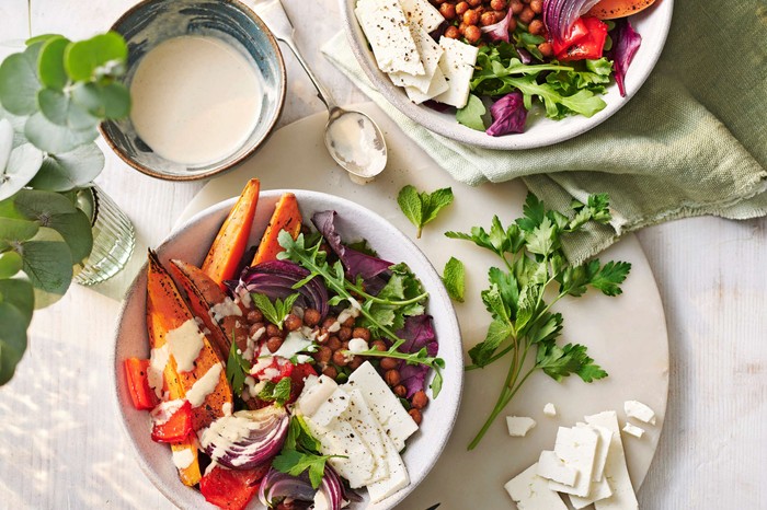 Two buddha bowls with a dip on the side