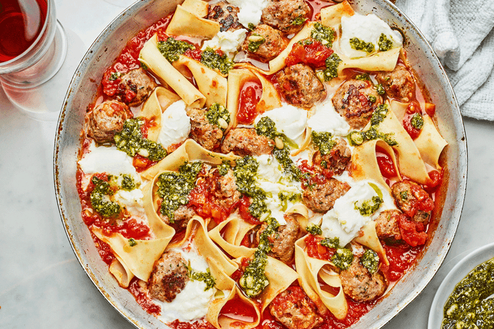 Spicy meatball pan lasgane Spicy meatball pan lasagne garnished with pesto