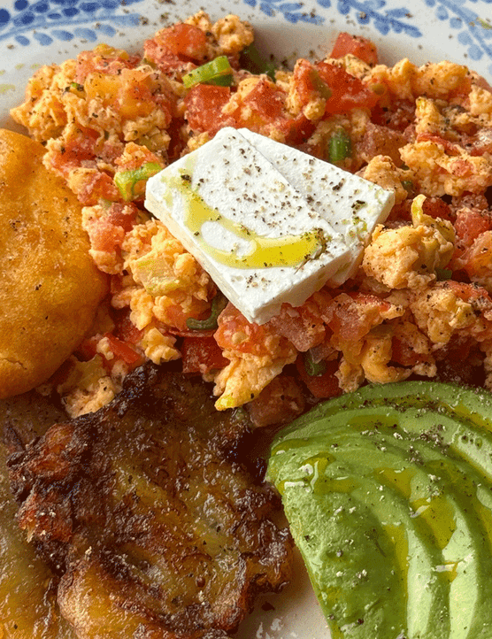 Colombian scrambled eggs on a plate with arepa
