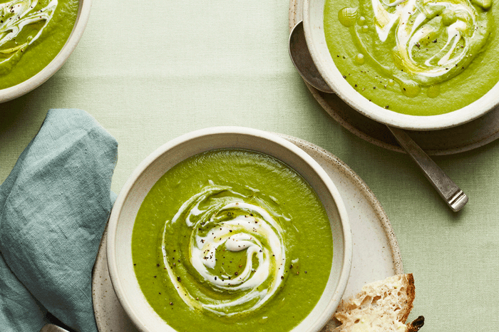 Wild garlic soup Bowls of green wild green soup topped with a swirl of crème fraîche